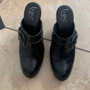 Black buckled clogs